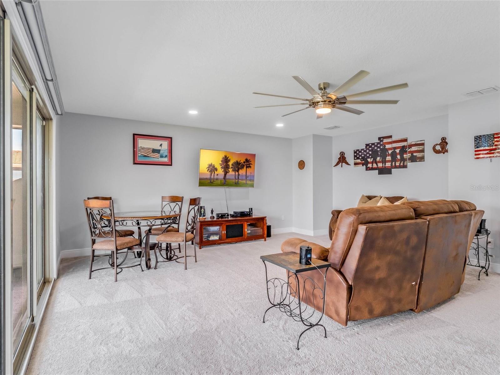 loft with brown furniture and tv
